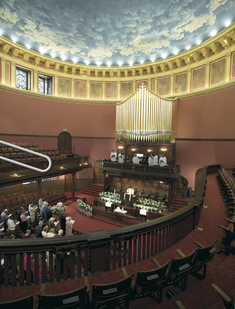 Church sanctuary with wine-red walls and grand organ